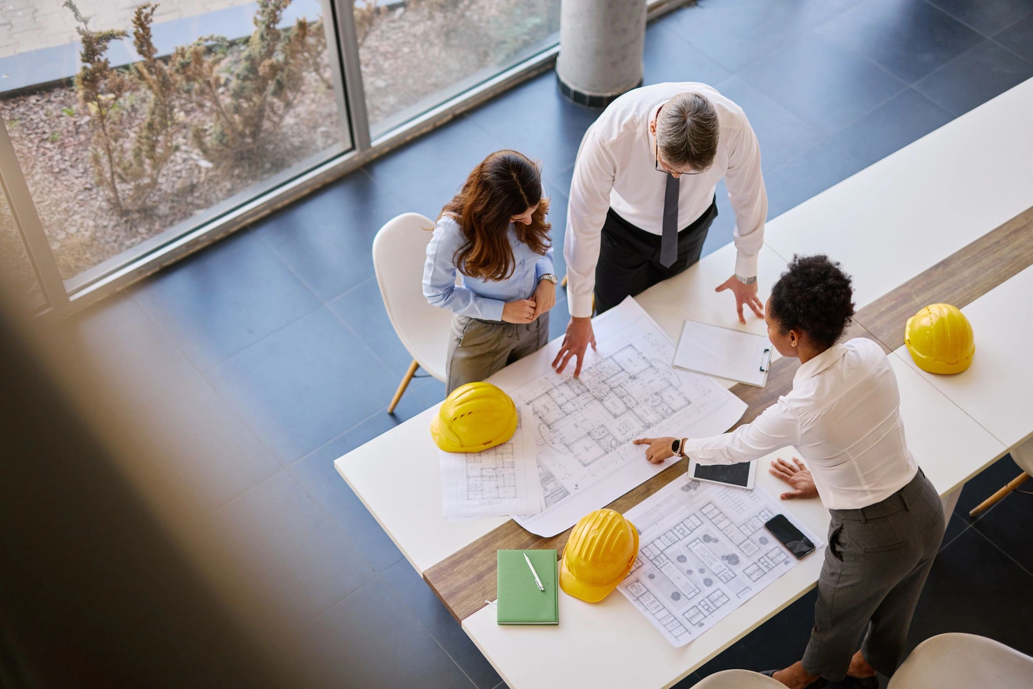 Architects and engineers reviewing project blueprints in a collaborative meeting